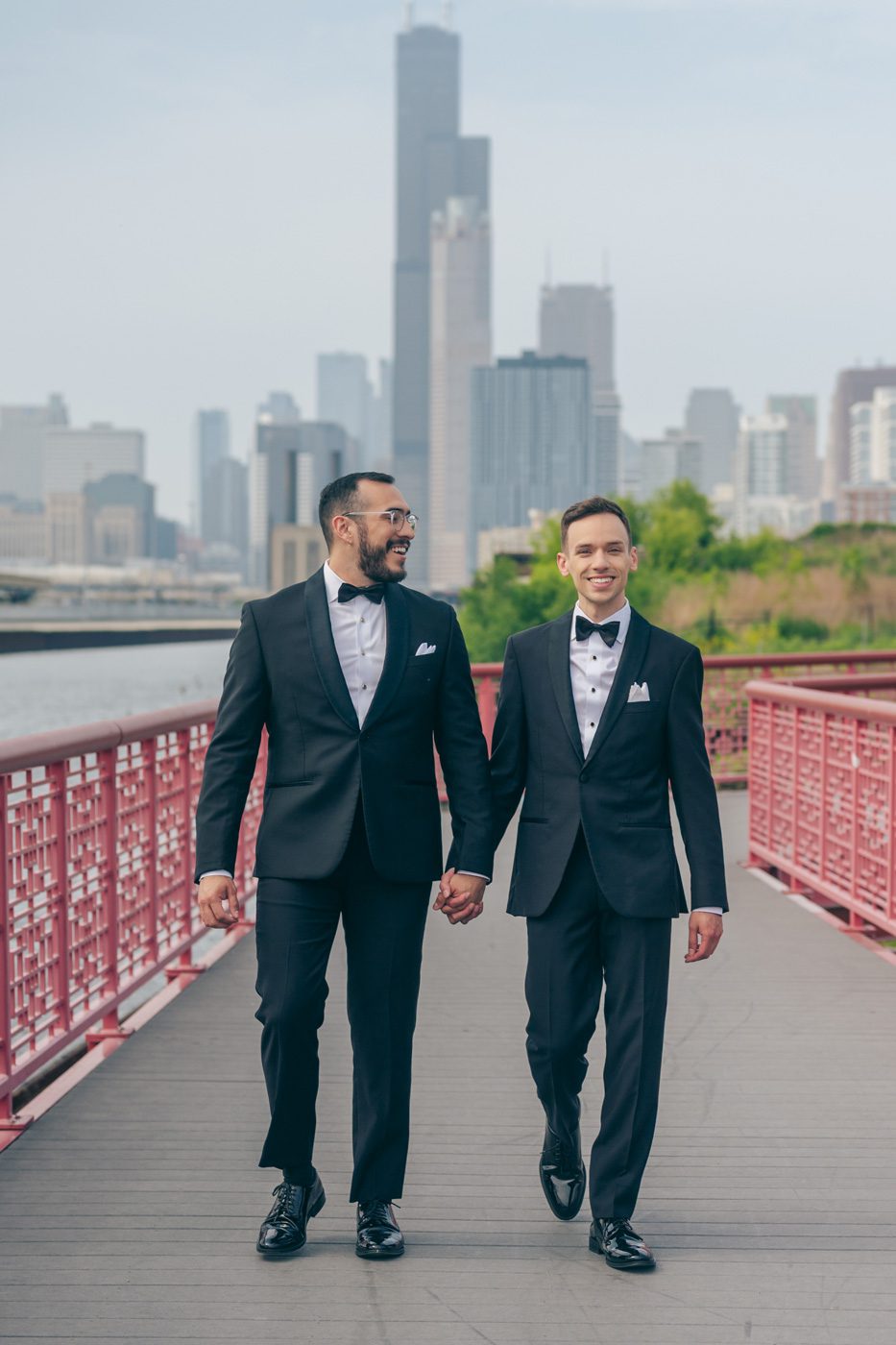 married couple walks front of the chicago skyline at ping tom park